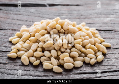 Group of pine nuts on the wooden table. Organic food. Stock Photo