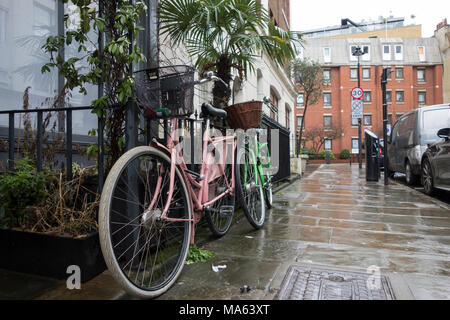 Vintage bicycles parked outside a property on Warren Street, Camden, London, NW1, UK Stock Photo