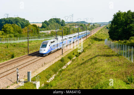 A double-decker high-speed TGV Duplex train in Atlantic livery from french company SNCF, driving on the South-East TGV line along the A5 highway. Stock Photo