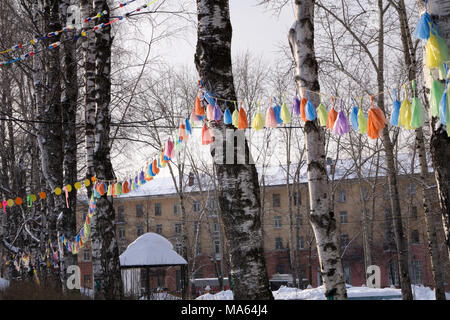 Garland decoration at the fair. Decorations of colorful pennants and colorful flag in the courtyard of the festival. Strings with flag Stock Photo
