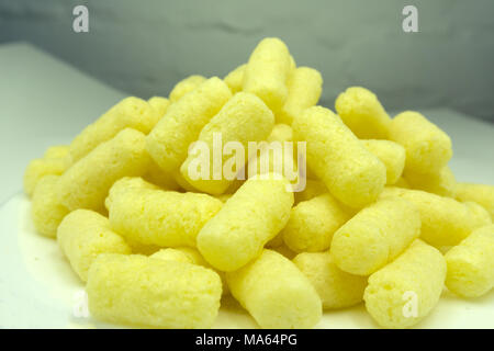 Sweet crunchy corn sticks or snacks isolated on white background Stock Photo