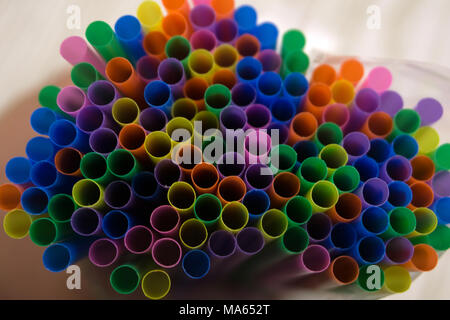 Colorful paper straws on white wooden background. Event and party supplies Stock Photo