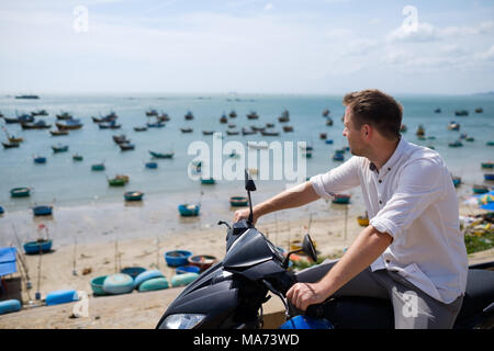 Caucasian man without helmet sit on motorbike. Stock Photo