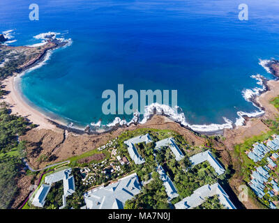 An aerial view of the golden beach and palm tree's at Hulopo'e Beach Park, and the Four Seasons resort at Manele Bay, Lanai Island, Hawaii, USA. Stock Photo