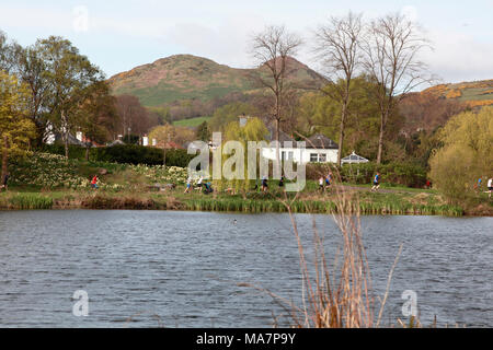 Participants in the Portobello 5K parkrun running around Figgate Pond with Arthur’s Seat in the background Stock Photo