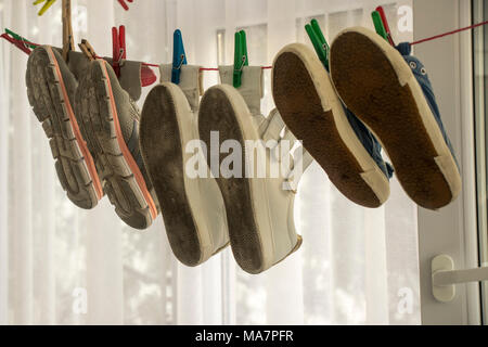 Different shoes on wire scene Stock Photo