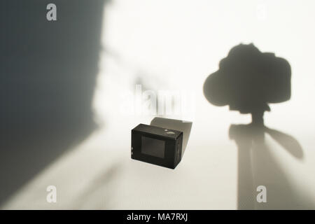 action camera on white surface with shadows Stock Photo