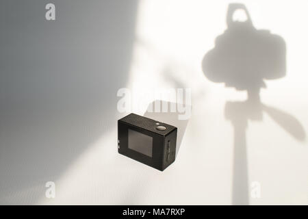 action camera on white surface with shadows Stock Photo