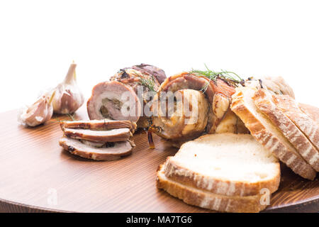 Roll of meat with various spices and herbs on a white background Stock Photo