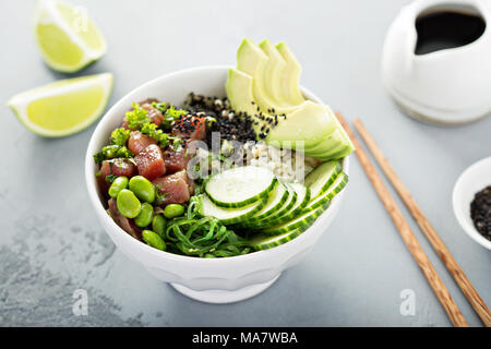 Poke bowl with raw tuna, rice, seaweed and vegetables Stock Photo