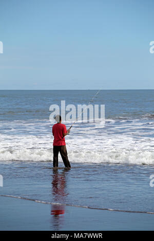 Man fishing on an asian beach Stock Photo