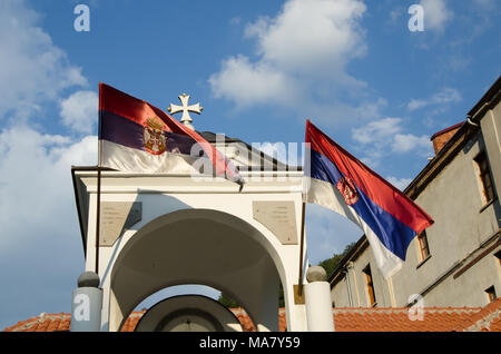 Prohor Pcinjski,Serbia,September 02, 2016:   tower with cross and serbian flags.Monastery of  Prohor Pcinjski is one of the oldest Serbian Monasteries Stock Photo