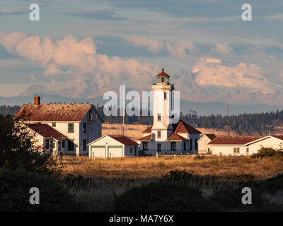 Port Townsend Lighthouse at Point Wilson located in Fort Worden state park, Port Townsend. Built in 1913 and automated in 1976. Mount Baker. Stock Photo