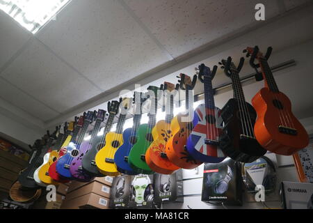 Multi-colored ukulele guitars in a musical instrument store Stock Photo