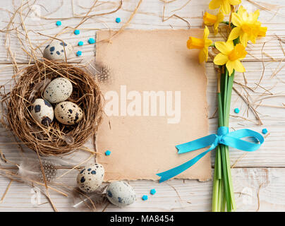 Easter background with Easter eggs and spring flowers. Top view with copy space. Stock Photo