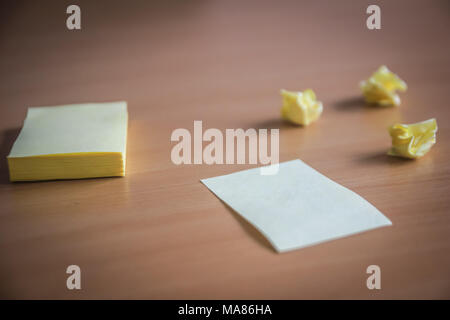 collection of pins and note paper bunch and loose papers on wooden board. side view ready to fill your text and design quotes. many folded paper denot Stock Photo
