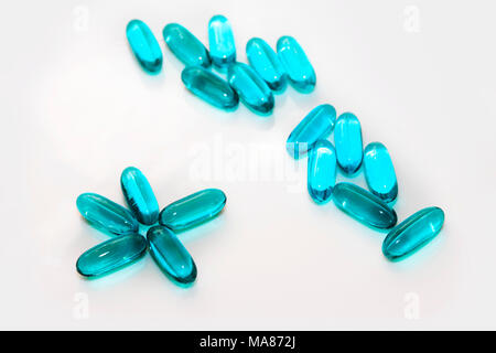 Blue capsules on white background close up Stock Photo