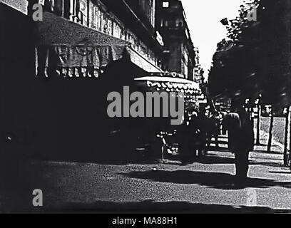 PARIS, FRANCE - CIRCA 1960: historical street life and traffic on Boulevard des Capucines, with famous shops, banks and historic restaurants. Street of Paris opera ballet theater. Archival 60s France. Stock Photo