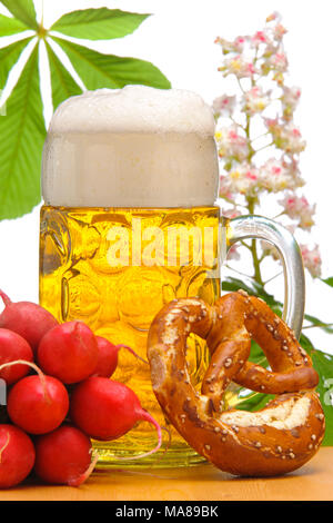 big glass filled with Bavarian lager beer and snack for beer garden Stock Photo