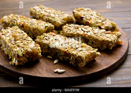 Granola bar. Healthy energy snack on wooden board. Close up view Stock Photo