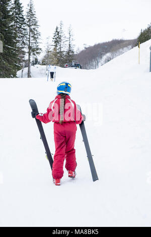 little girl holding ski Stock Photo
