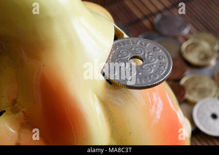 Denmark coin with a denomination of five krone (crown) in the hole of money box, coins background Stock Photo