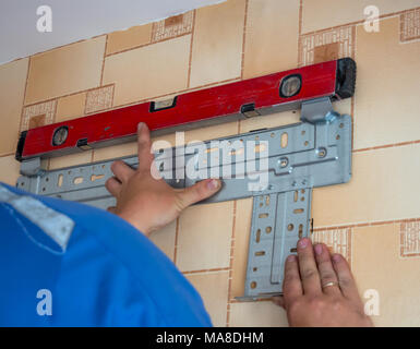 Mounting the mounting bracket with a level Stock Photo