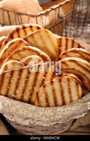 Fresh toast in basket on wooden background Stock Photo