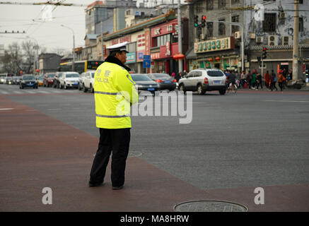 A traffic policeman manages traffic flow at an intersection in Beijing, China Stock Photo