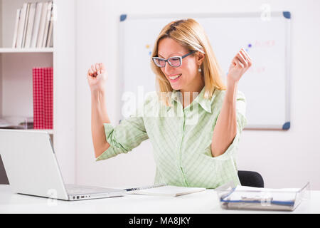 Cheerful businesswoman is working in her office. Stock Photo