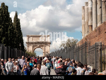 Crowds of tourists pass on a day in early March along Via Sacra towards Arco di Tito, the Arch of Titan, Rome Stock Photo