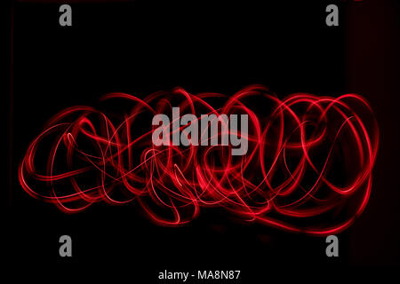 Red color abstract light painting. LED lights on black background Stock Photo