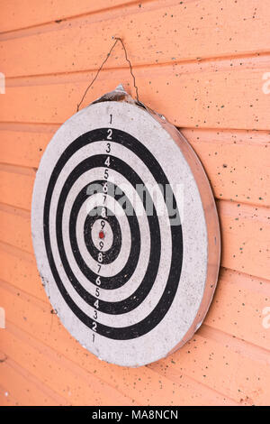 Old darts game on wooden wall Stock Photo