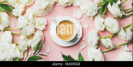 Cup of coffee and white ranunculus flowers on pink background Stock Photo