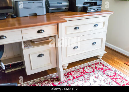 Simple wooden home office room drawers in house closeup in staging model apartment, home, carpet, with chair and decorations Stock Photo