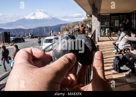 Black eggs cooked in the sulfur of Mount Hakone and sold in Owakudani shops with Mount Fuji in the background Stock Photo