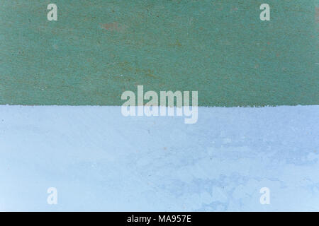 Magnificent background of the green wall is half painted with a white putty 2018 Stock Photo