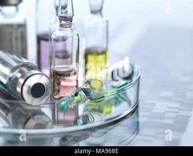 Personalised medicine, conceptual image. Variety of drugs sitting on a DNA (deoxyribonucleic acid) autoradiogram. Stock Photo