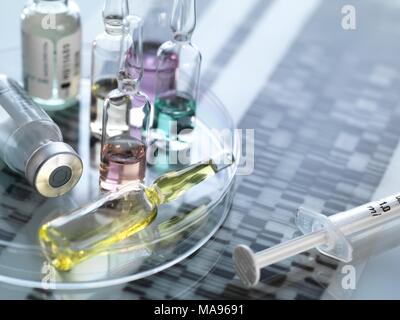 Personalised medicine, conceptual image. Variety of drugs sitting on a DNA (deoxyribonucleic acid) autoradiogram. Stock Photo