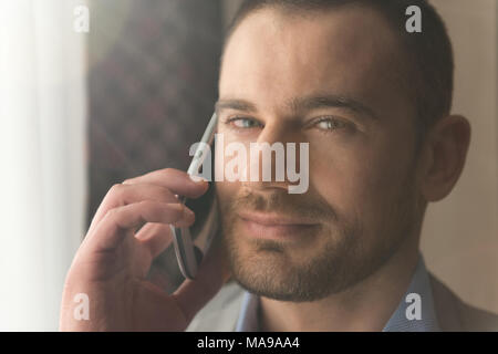 Happy Young Business Man Work In Modern Living Room and Talking On the Phone Stock Photo
