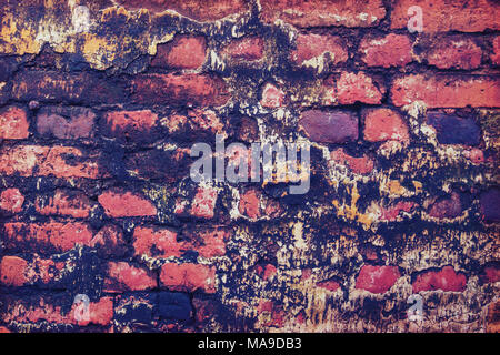 Background old red brick with mold. Old, decayed wall with peeling plaster. Brick wall painted in bright colors Stock Photo