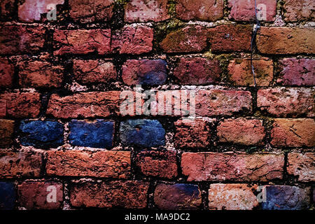 Old red brick wall texture. Brick wall painted in bright colors Stock Photo