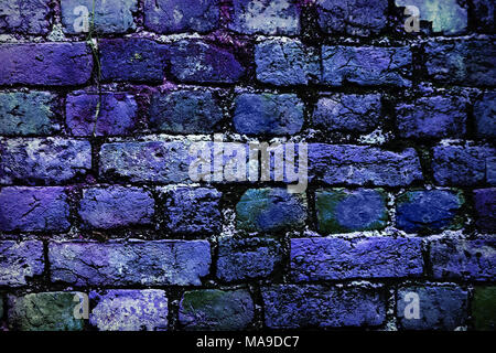 deep blue brick wall background faded on black. Brick wall painted in bright colors. Blue bricks in the wall. Stock Photo