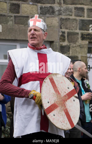 Heptonstall, UK. 30th March, 2018. A traditional Pace Egg play is performed in Heptonstall’s Weavers Square on Good Fridays, attracting hundreds of visitors to the village. The origins are uncertain, but some version of the plays have undoubtedly been performed over many hundreds of years. In the play St George takes on contenders such as Bold Slasher, the Black Prince of Paradine and Hector. Credit: Steve Morgan/Alamy Live News Stock Photo