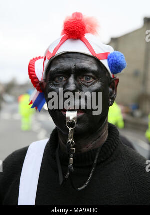 Lancashire, UK, 31 Mar 2018. The Britannia CoCo Nut Dancers, with blacked out faces and wearing clogs, performing on the streets of Bacup, Lancashire, 31st March, 2018 (C)Barbara Cook/Alamy Live News Stock Photo