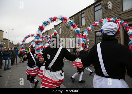 Lancashire, UK, 31 Mar 2018. The Britannia CoCo Nut Dancers, with blacked out faces and wearing clogs, performing on the streets of Bacup, Lancashire, 31st March, 2018 (C)Barbara Cook/Alamy Live News Stock Photo