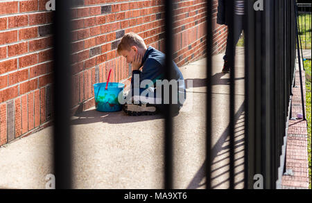 Alabama, USA, 31 Mar 2018. Six-year-old Cohen Carter, sits paitently waiting for the start of the Easter Egg Hunt on Saturday, March 31st 2018 in Vernon, Alabama. Credit: Tim Thompson/Alamy Live News Stock Photo