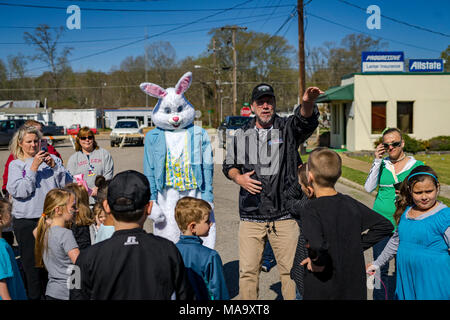 Alabama, USA, 31 Mar 2018. Vernon, Alabama Mayor Glenn Crawford, black jacket, gestures to where some of the one thousand plus eggs are hidden as the Easter Bunny looks on. The egg hunt was held on Saturday, March 31st, 2018. Credit: Tim Thompson/Alamy Live News Stock Photo