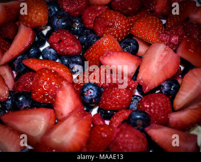 Fresh Strawberries, blueberries and raspberries in a bowl Stock Photo