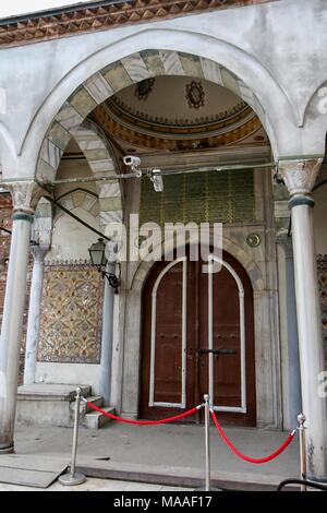 Exterior view, from a low angle, showing the Ottoman style, arched and domed entrance portico, with Corinthian columns, multi-colored tilework, bench, and large arched doors leading into the Aya Irini (Hagia Irene), a former Greek Eastern Orthodox church, now used as a museum and concert hall, located in the outer courtyard of Topkapi Palace in Istanbul, Turkey, November 16, 2017. () Stock Photo
